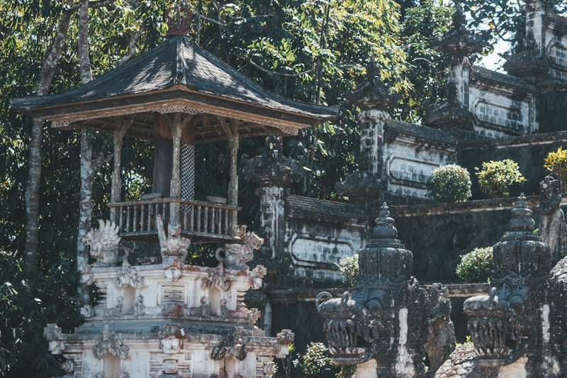 Ancient Indonesian temple surrounded by lush tropical forest canopy